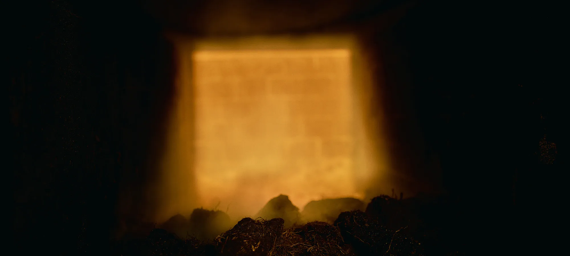 Blurred image of peat inside kiln.